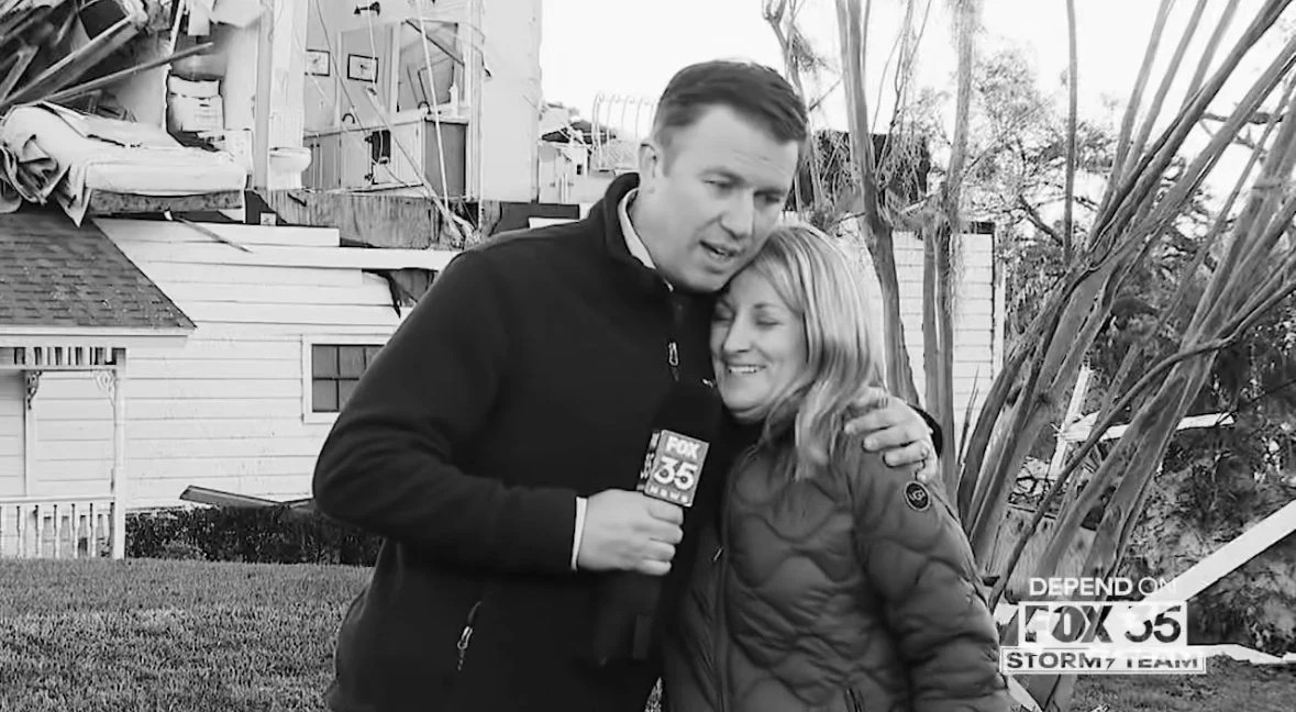 Brooks Garner speaking with a homeowner following tornado damage